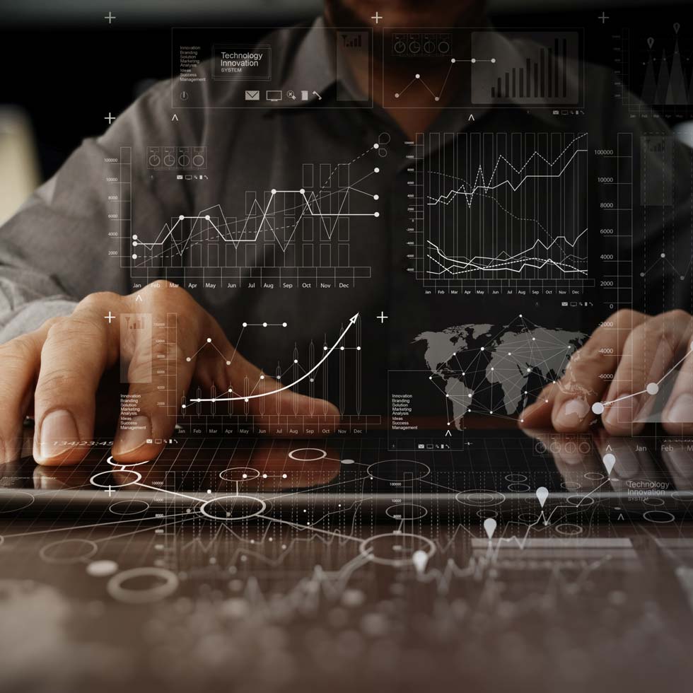 Man at computer looking at data with overlaid stats and charts